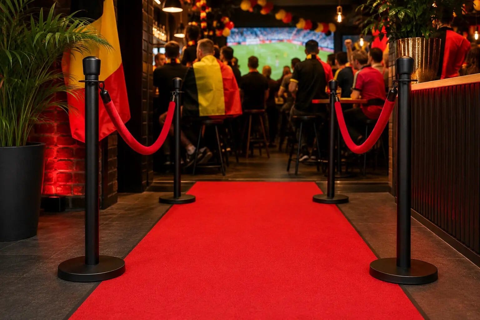 WK Rode Duivels Bundel Indoor by Rodelopers; red carpet entry with black stanchions and Belgian flag.